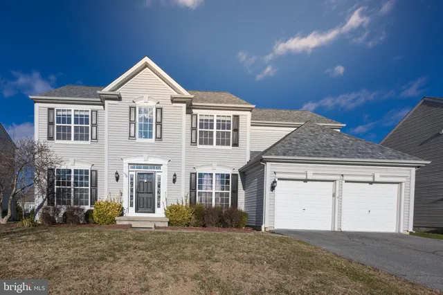 a view of a room with a window and wooden floor
