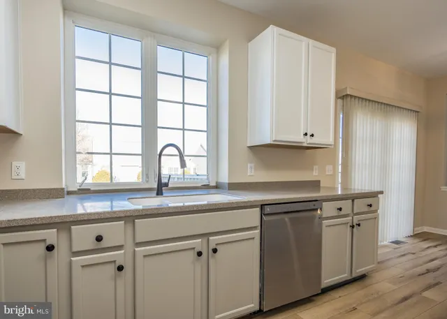 a kitchen with stainless steel appliances a refrigerator sink and cabinets