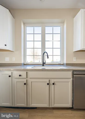 a kitchen with wooden floors and white appliances