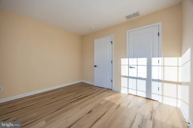 a view of a house with backyard and wooden fence