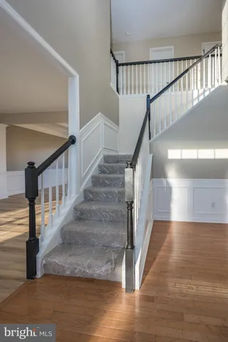a kitchen with granite countertop white cabinets and a window