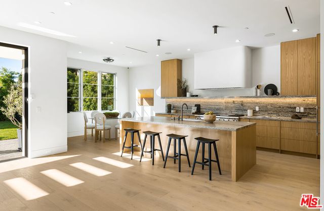 a kitchen with stainless steel appliances granite countertop a sink and a stove