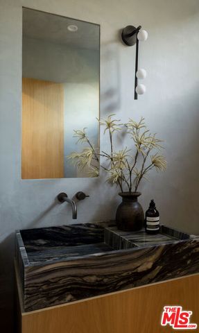 a bedroom with bed and glass windows