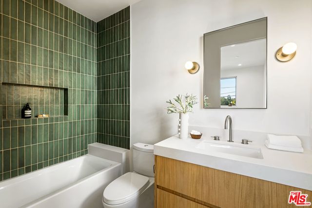 a living room with furniture and a large screen