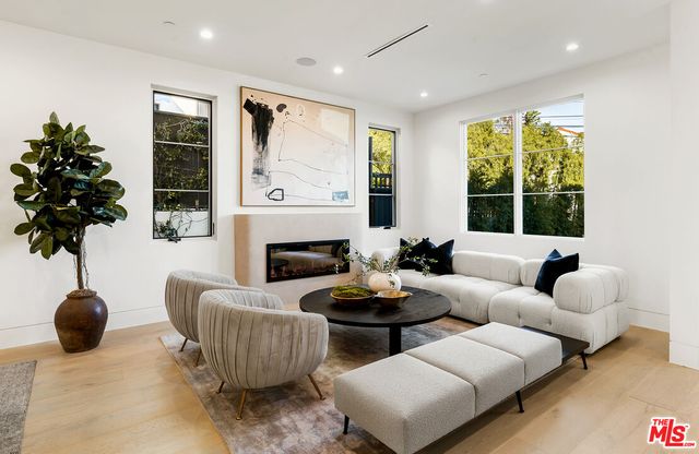 a living room with furniture potted plant and a window