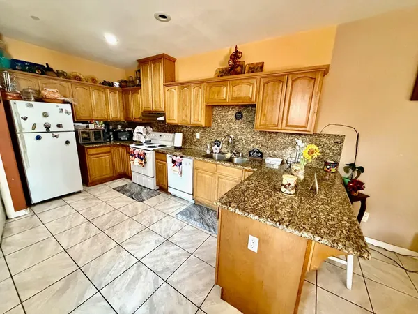 a kitchen with a sink appliances and cabinets