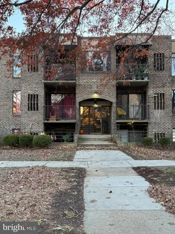 a view of a brick house with many windows