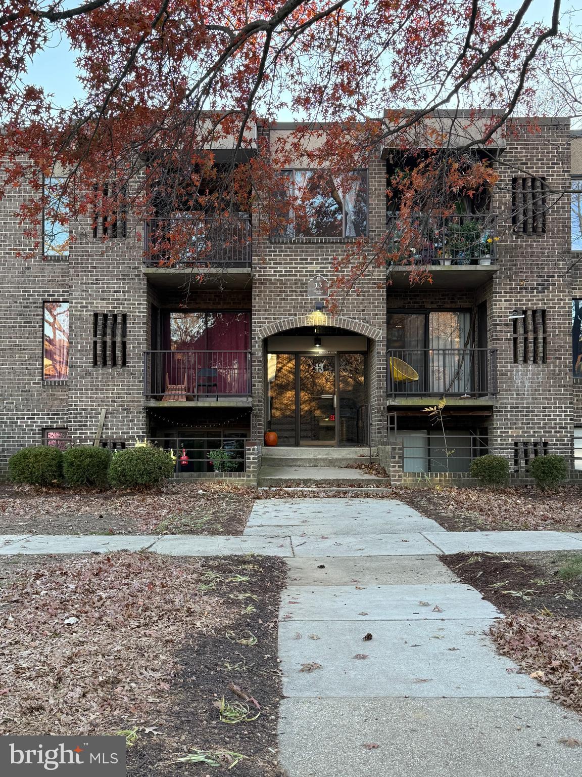 a view of a brick house with many windows