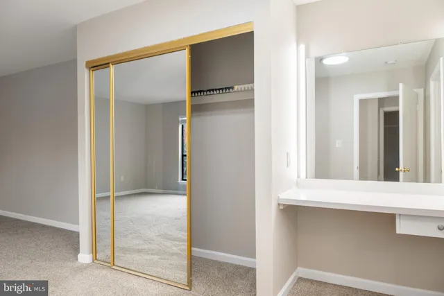 a bathroom with a toilet a sink and a mirror