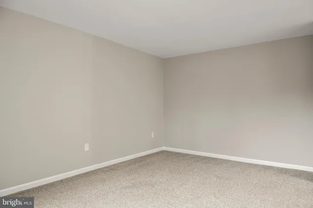 an empty room with closet and a bathroom