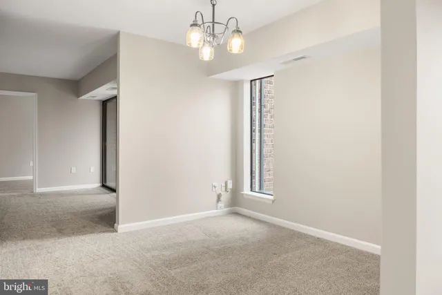 an empty room with a ceiling fan and a window