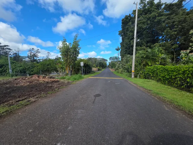 a view of a road with a building in the background