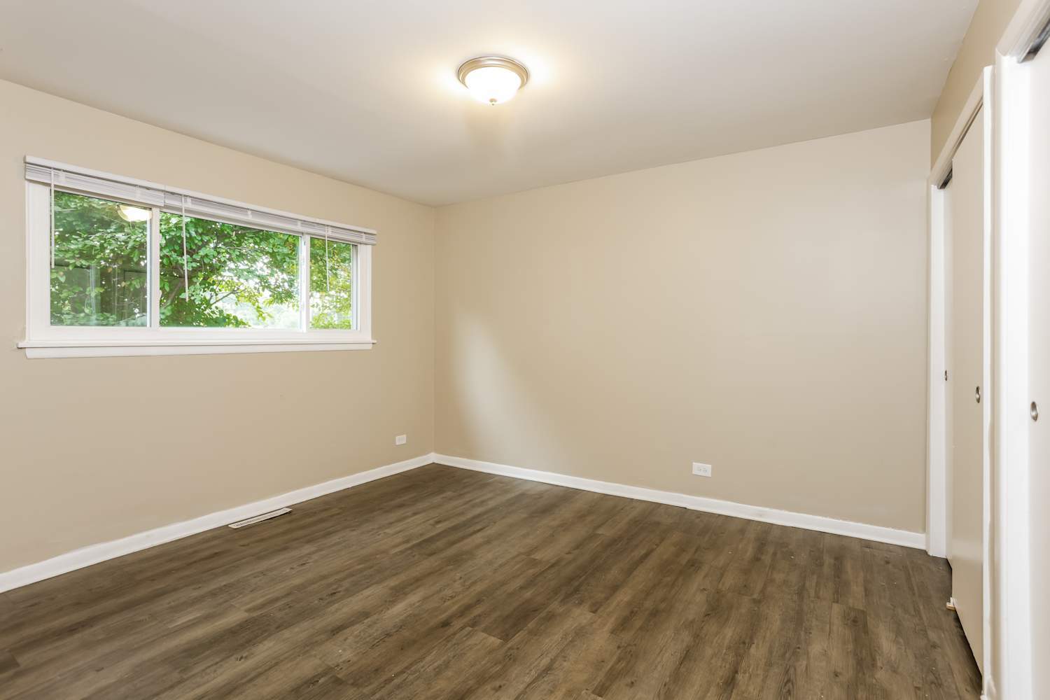 1462 Deerfield Road Deerfield, IL 60015 - Photo 11 of 14 an empty room with wooden floor and windows