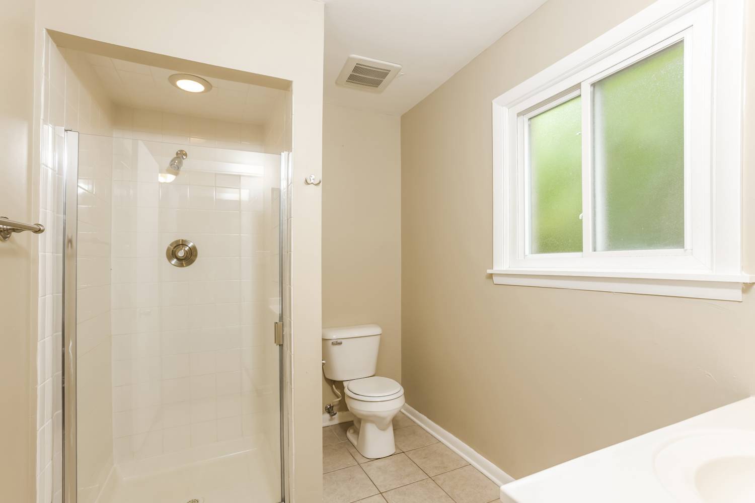 1462 Deerfield Road Deerfield, IL 60015 - Photo 4 of 14 a bathroom with a granite countertop toilet a sink a shower and a window