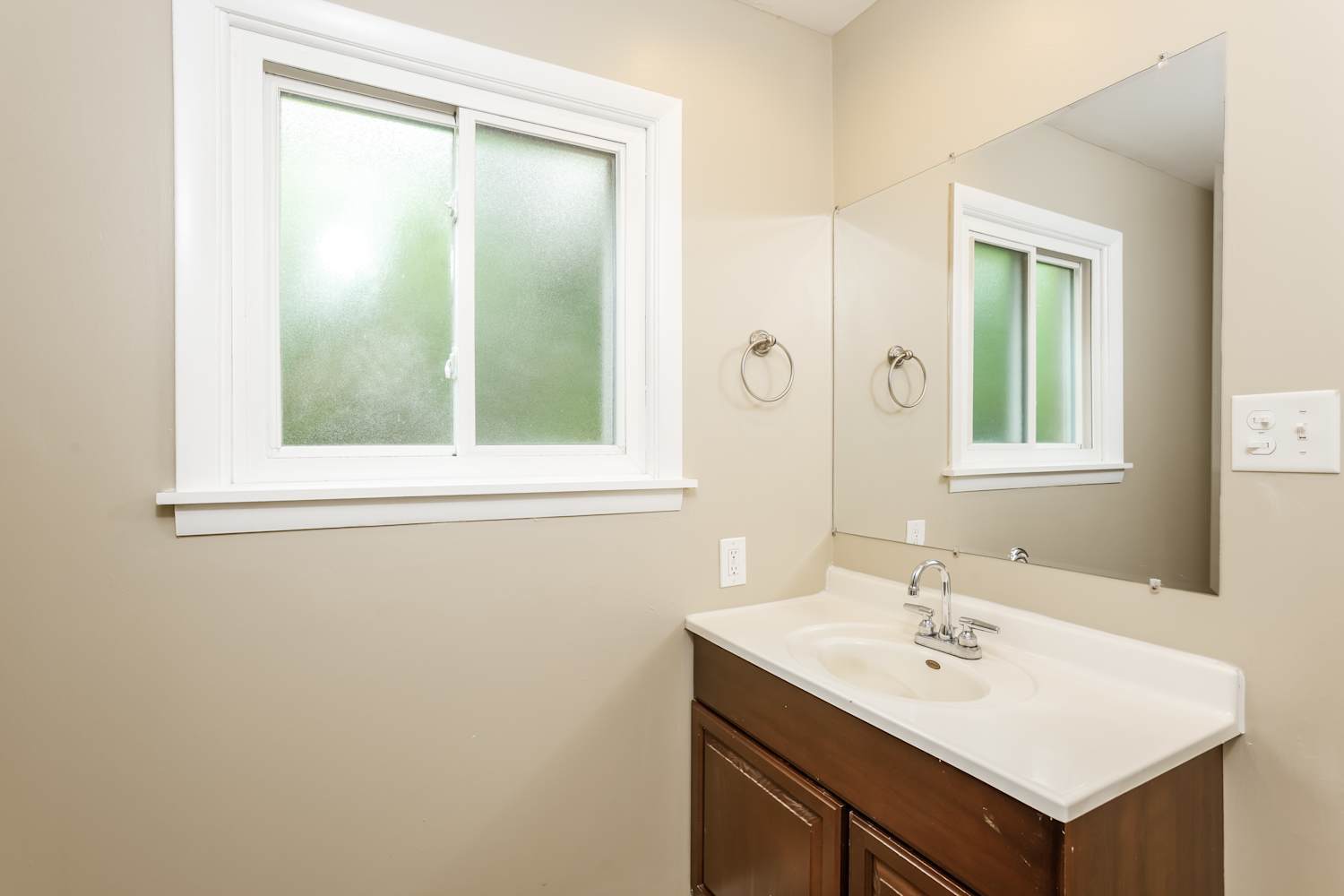 1462 Deerfield Road Deerfield, IL 60015 - Photo 9 of 14 a bathroom with a sink a mirror and a window