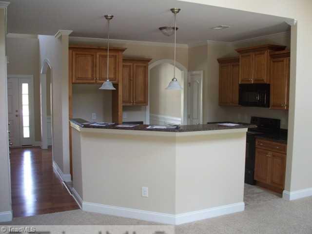 6311 Ridge Haven Road Greensboro, NC 27410 - Photo 4 of 12 Kitchen. Large kitchen with grnaite tops, black appliances.