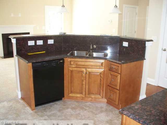 6311 Ridge Haven Road Greensboro, NC 27410 - Photo 5 of 12 Kitchen. Work ing the kitchen and enjoy what is going on in the living room.