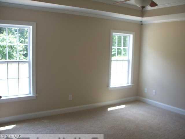 6311 Ridge Haven Road Greensboro, NC 27410 - Photo 7 of 12 Master Bedroom. Large Master Bedroom with tray ceiling and ceiling fan.