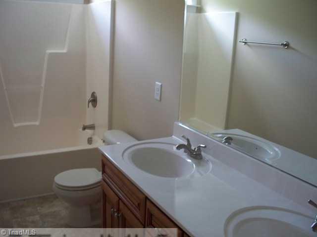 6311 Ridge Haven Road Greensboro, NC 27410 - Photo 10 of 12 Other. Family Bath with double sinks and tub/shower combo.