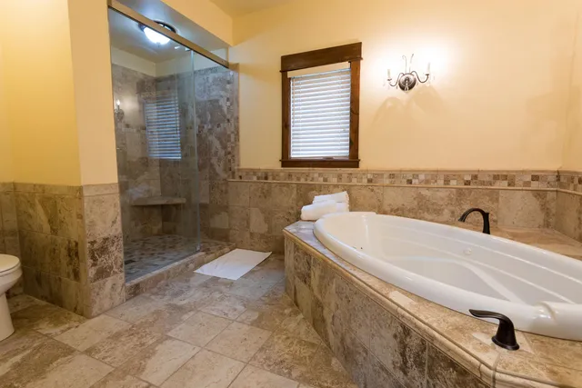a bathroom with a bathtub and shower