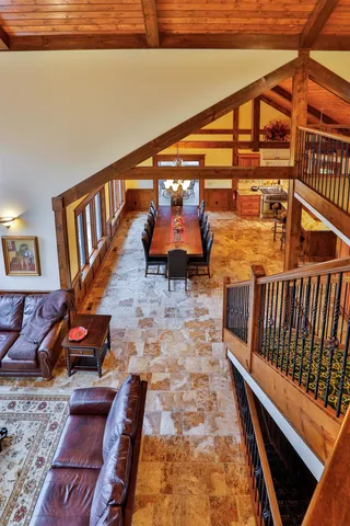 a living room with furniture a fireplace and a floor to ceiling window