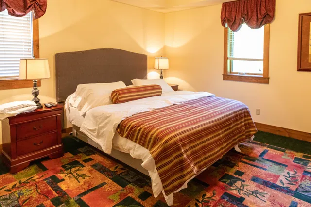 a view of a roof deck with wooden fence and trees