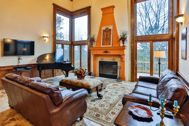 a living room with furniture fireplace and a flat screen tv
