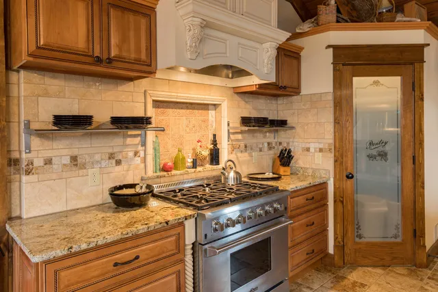 a kitchen with stainless steel appliances granite countertop a sink and cabinets