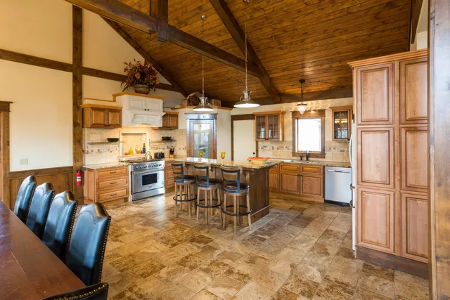 a view of kitchen with furniture and refrigerator