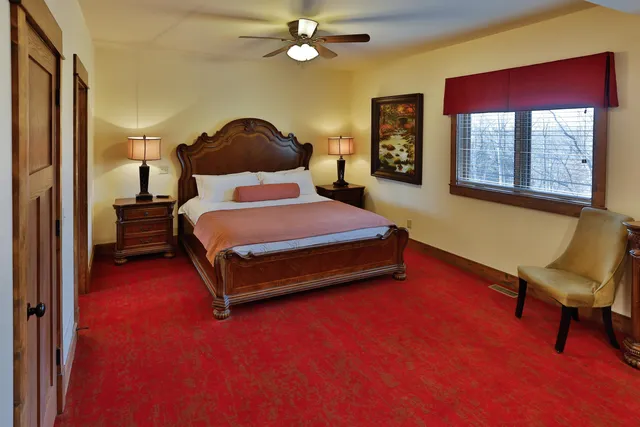 a bedroom with a bed chair and window