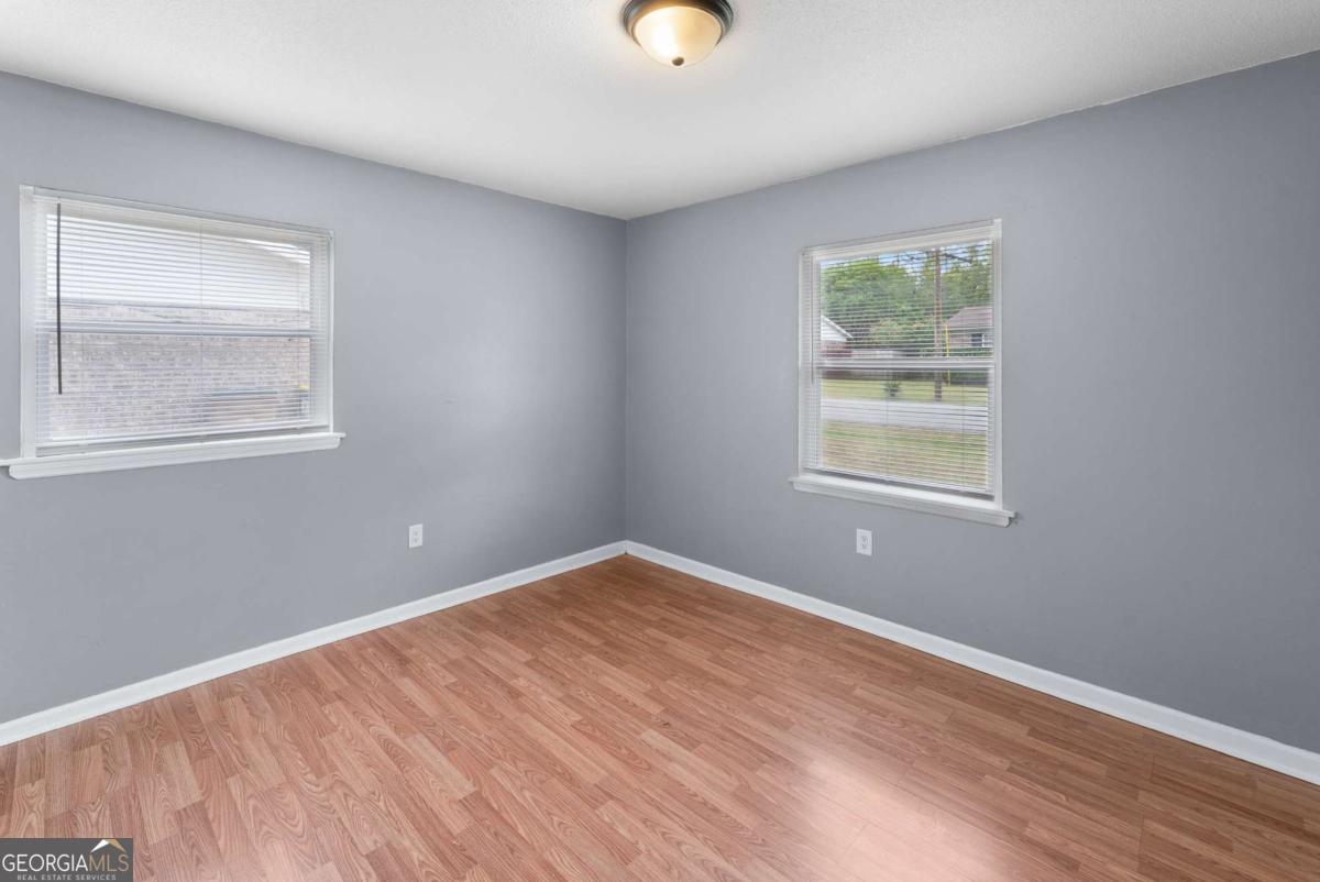 320 West Whatley Street Pooler, GA 31322 - Photo 14 of 34 an empty room with wooden floor and windows