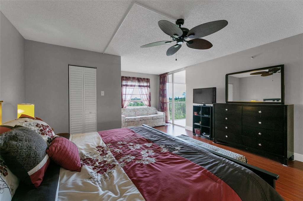 3940 Inverrary Boulevard, Unit 806A Fort Lauderdale, FL 33319 - Photo 19 of 36 a bedroom with a bed and a tv on dresser