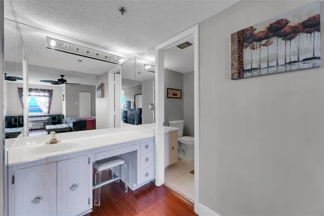 a bathroom with a sink a toilet and a mirror