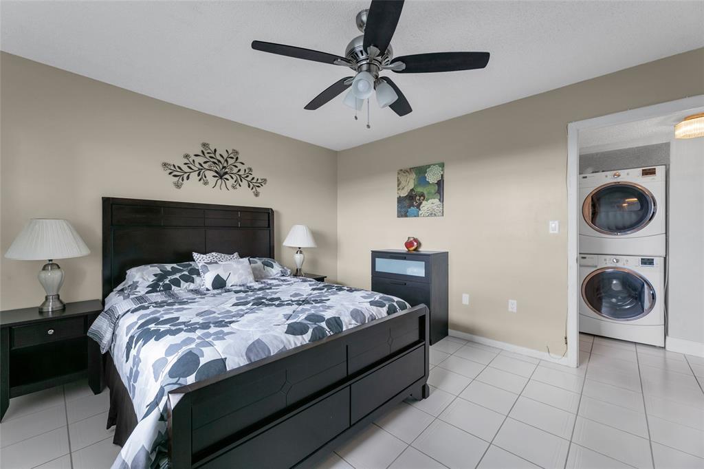 3940 Inverrary Boulevard, Unit 806A Fort Lauderdale, FL 33319 - Photo 7 of 36 a bedroom with a bed and a chandelier