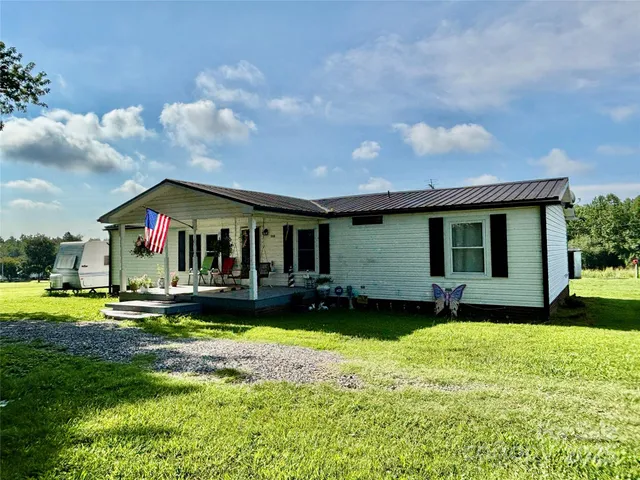 a front view of a house with a yard table and chairs
