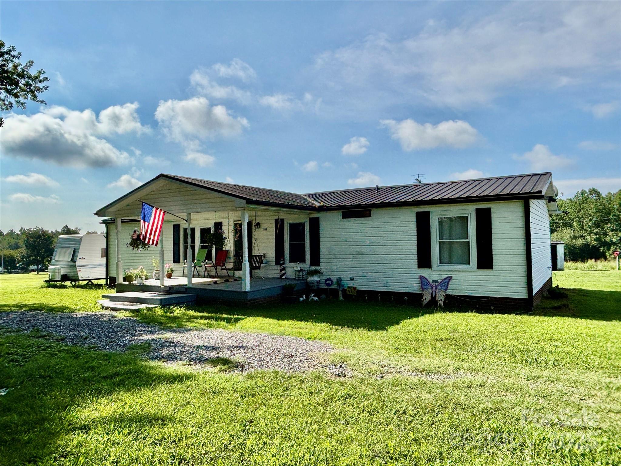 a front view of a house with a yard table and chairs
