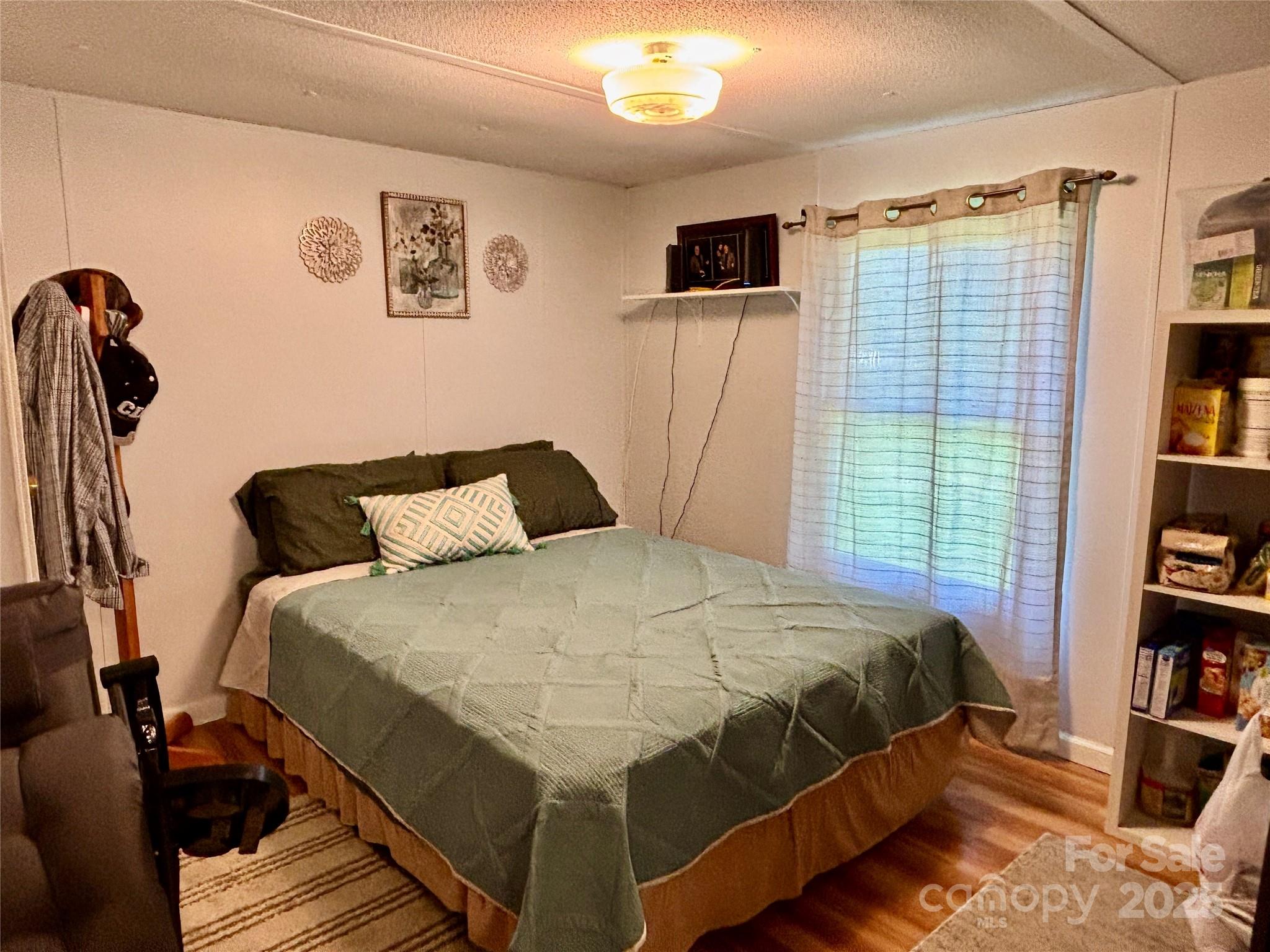 2830 Burgin Smith Road Vale, NC 28168 - Photo 12 of 38 a bedroom with a bed and a book shelf