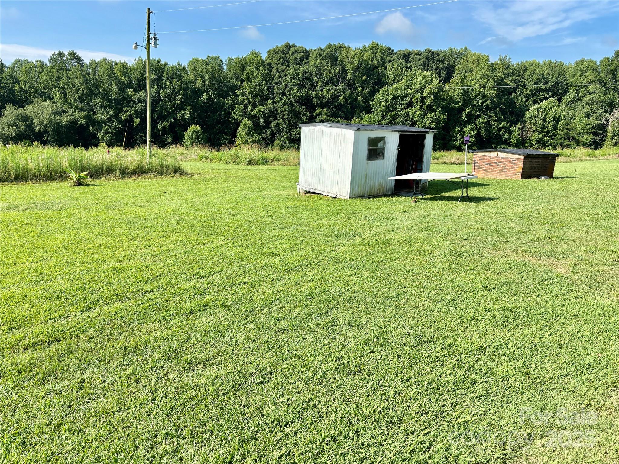 2830 Burgin Smith Road Vale, NC 28168 - Photo 29 of 38 a view of a white house with a yard and fence