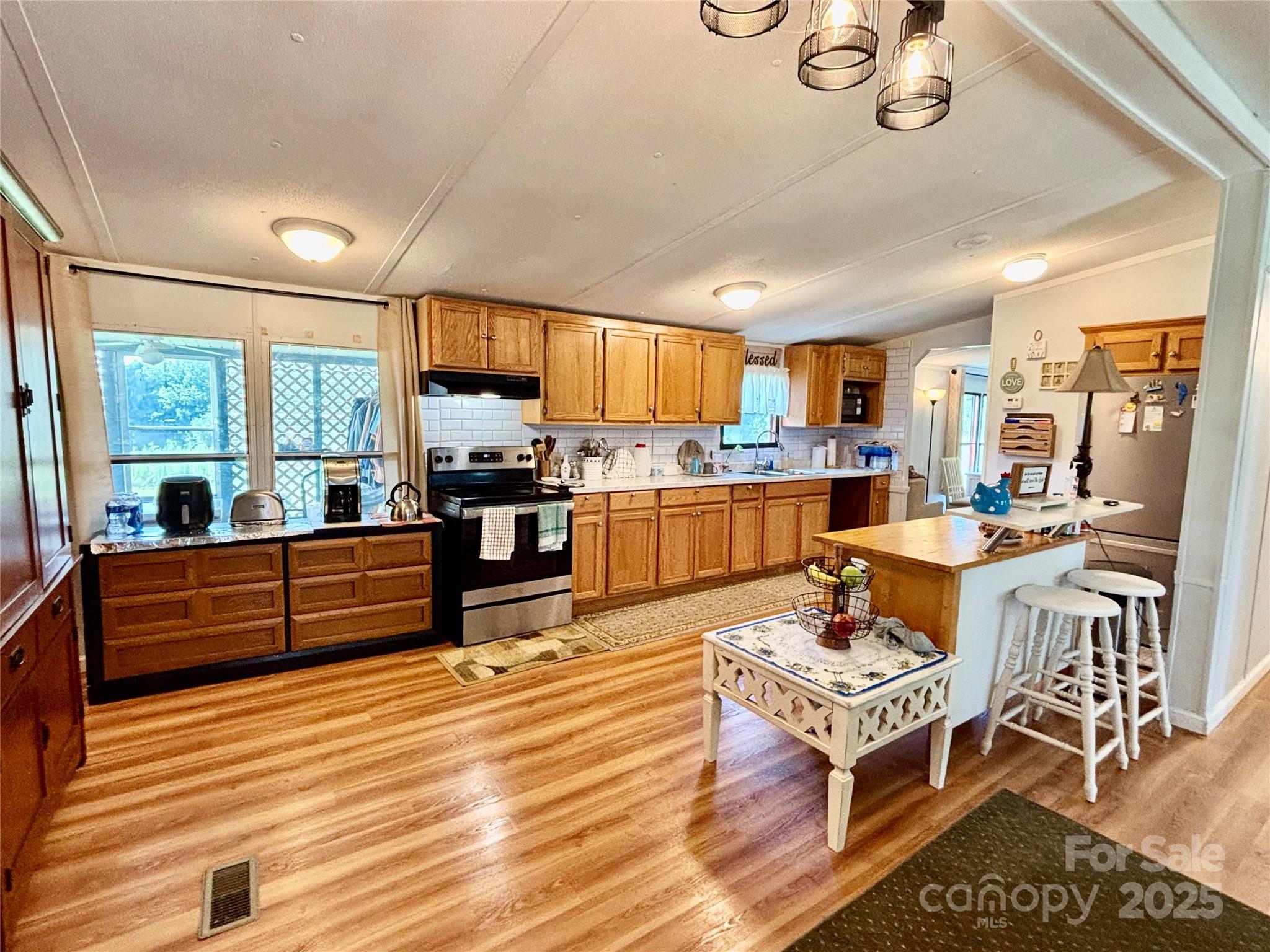 2830 Burgin Smith Road Vale, NC 28168 - Photo 3 of 38 a large kitchen with a table and chairs in it