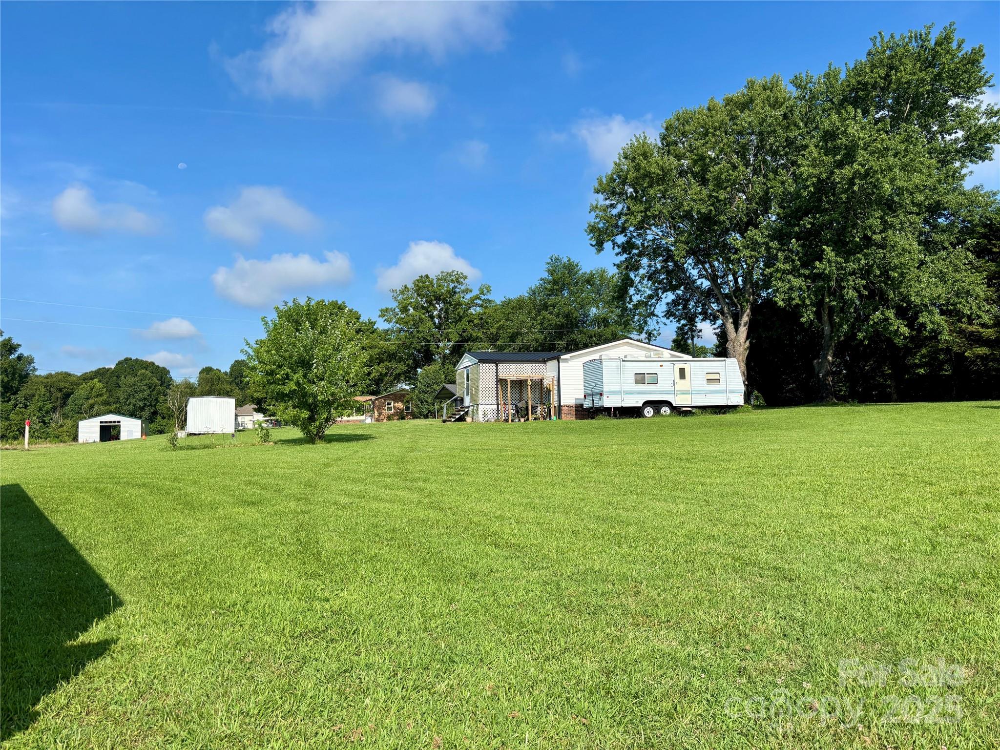 2830 Burgin Smith Road Vale, NC 28168 - Photo 31 of 38 a white house with a big yard and large trees