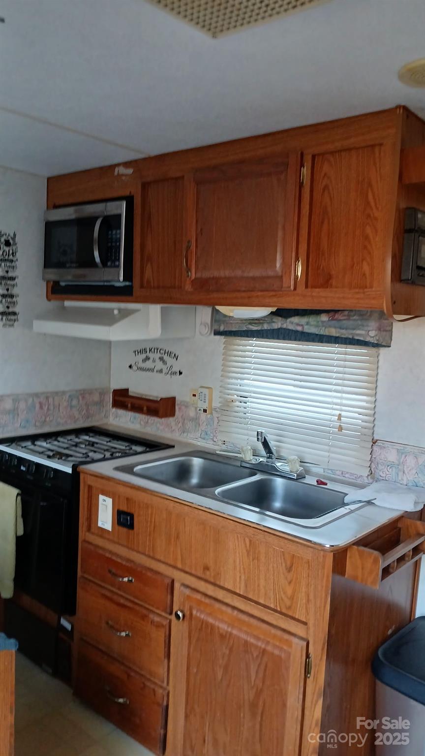 2830 Burgin Smith Road Vale, NC 28168 - Photo 38 of 38 a kitchen with stainless steel appliances granite countertop a sink stove and microwave