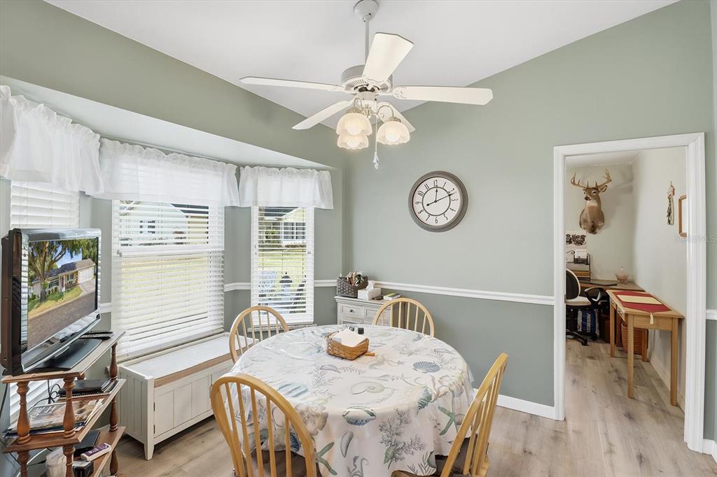 11263 Southwest 138th Lane Dunnellon, FL 34432 - Photo 11 of 53 a view of a dining room with furniture a chandelier and wooden floor