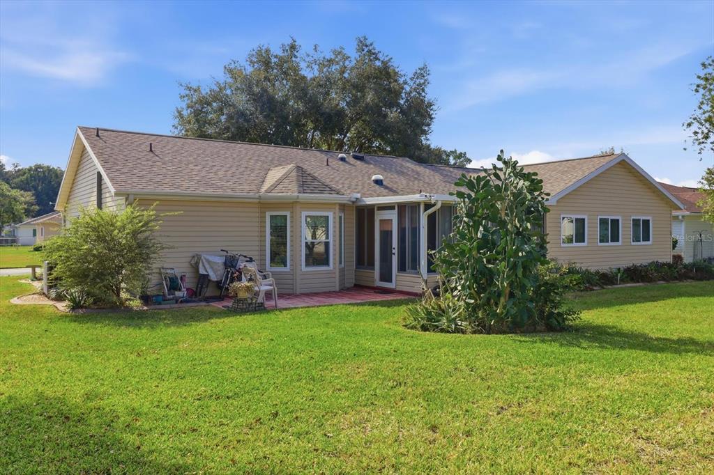 11263 Southwest 138th Lane Dunnellon, FL 34432 - Photo 36 of 53 a front view of a house with a garden and trees