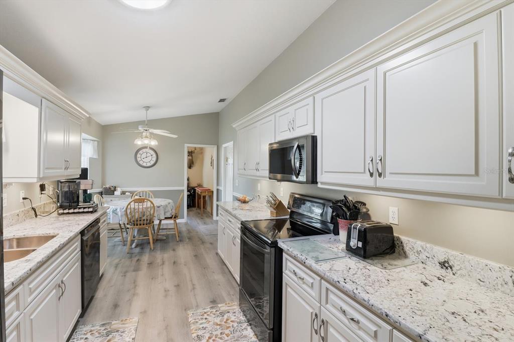 11263 Southwest 138th Lane Dunnellon, FL 34432 - Photo 8 of 53 a kitchen with granite countertop lots of counter top space and stainless steel appliances