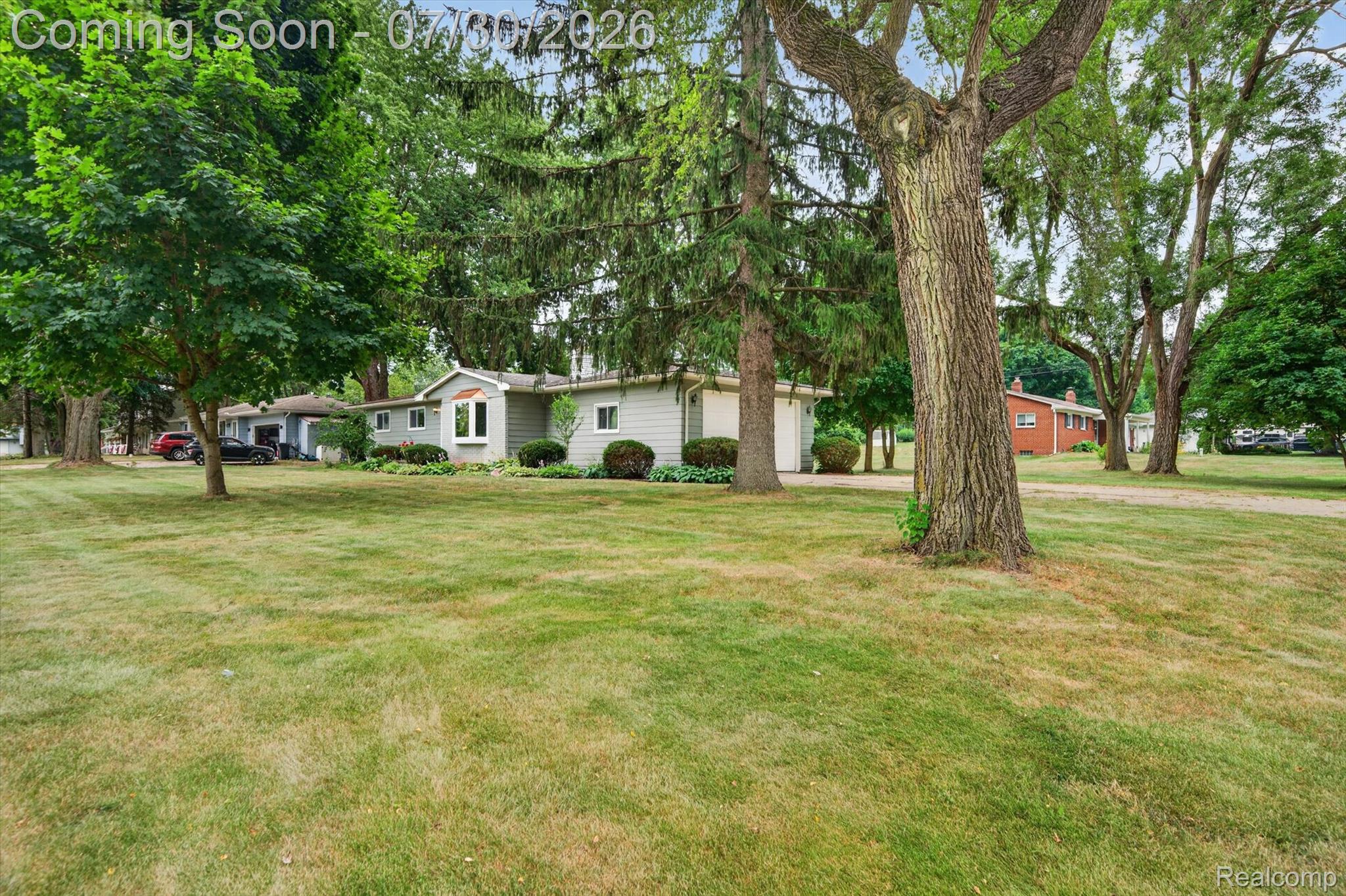 5991 Maybee Road Clarkston, MI 48346 - Photo 39 of 41 Expansive front yard featuring mature trees and a manicured lawn