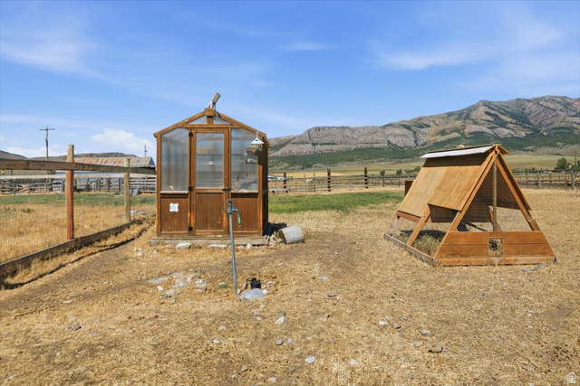1634 West Arimo Road Arimo, ID 83214 - Photo 50 of 89 Wood-framed greenhouse featuring clear paneling and a dedicated water spigot