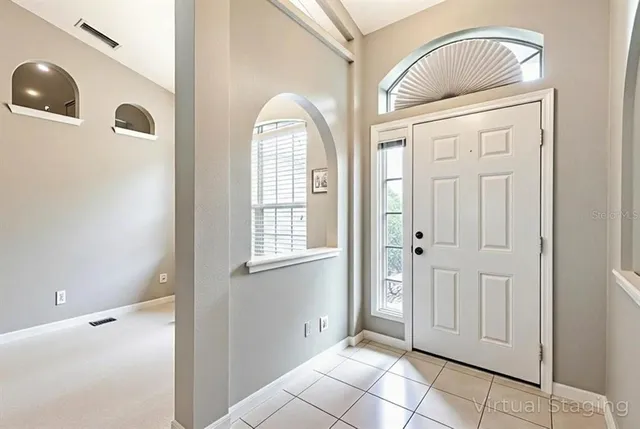 a bedroom with a large bed and a chandelier fan