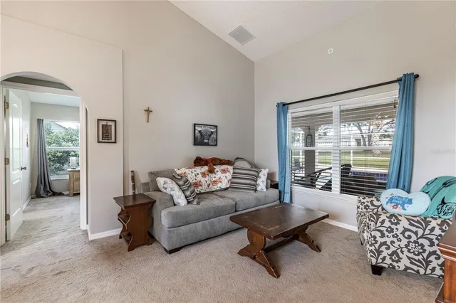 an empty room with a ceiling fan and window
