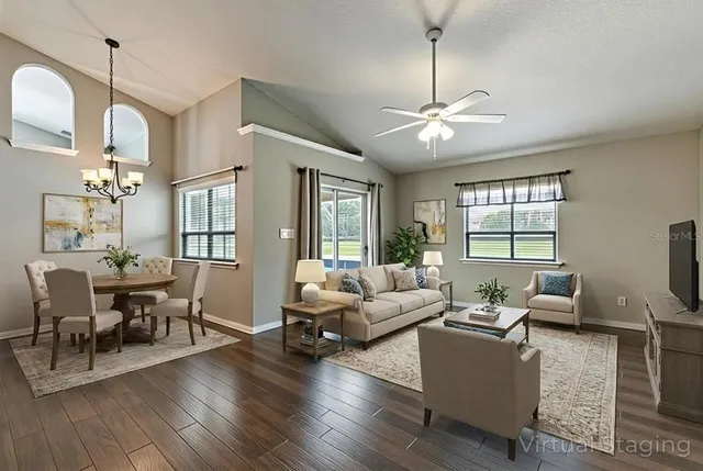 a view of a house with a big yard and large trees