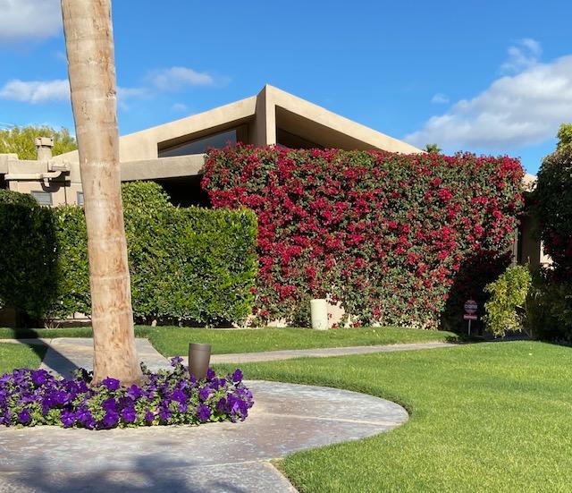 45735 Juniper Circle, Unit 522 Palm Desert, CA 92260 - Photo 1 of 53 a front view of a house with a yard and garage